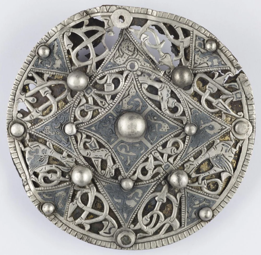 The Cheddar Brooch, a silver disc made around the year 900, worked with a two-legged wyvern